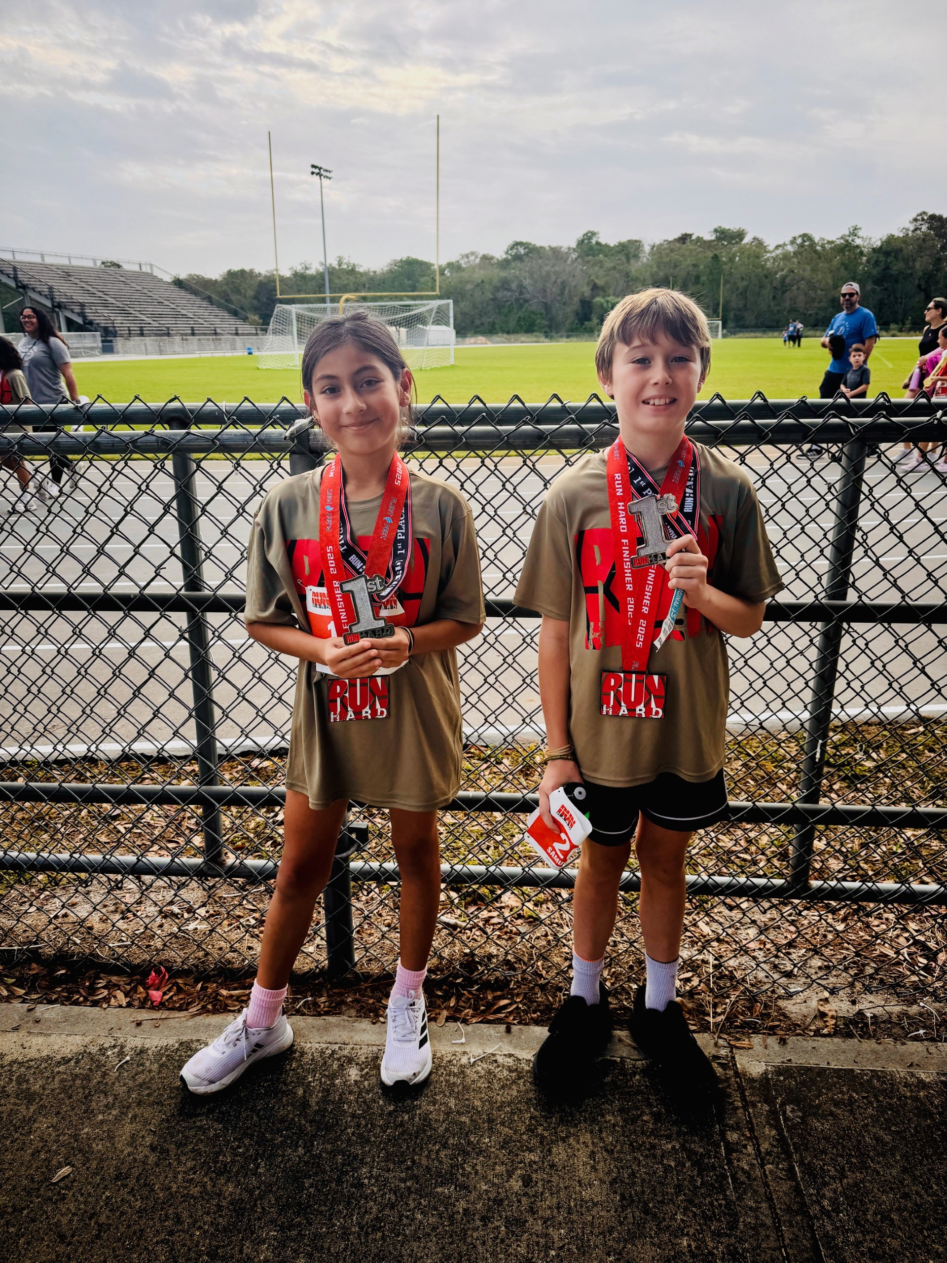 <p>Valeria and Samuel showing off their hard work at this past weekend's Run Hard event.</p>